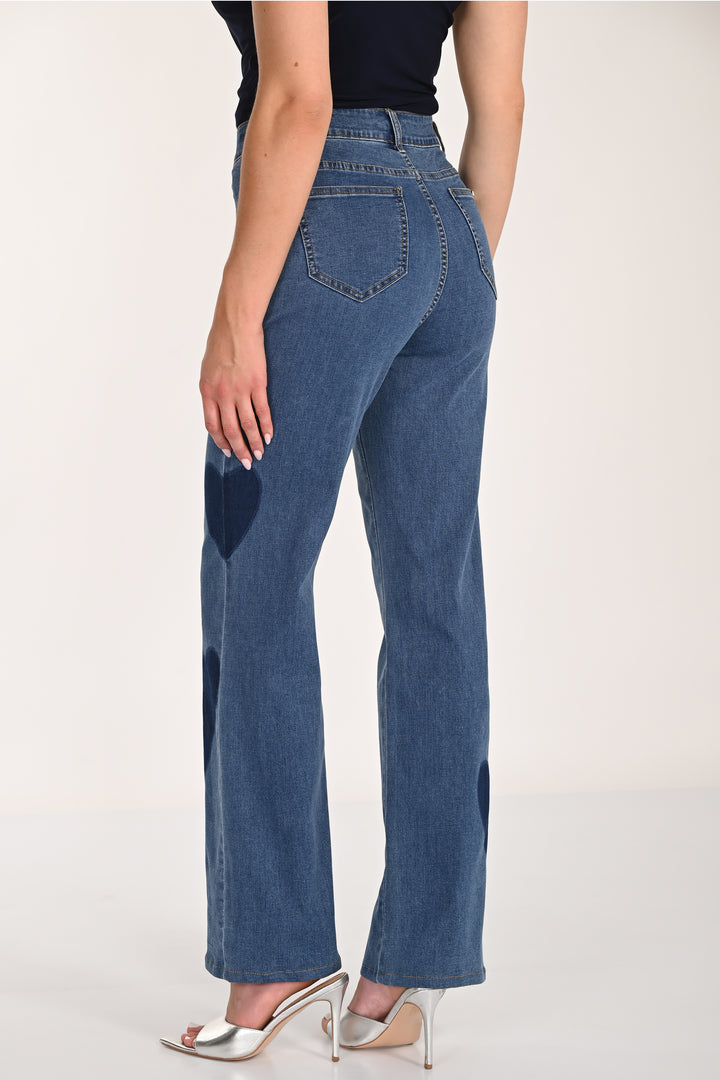 Person wearing blue jeans on a white background