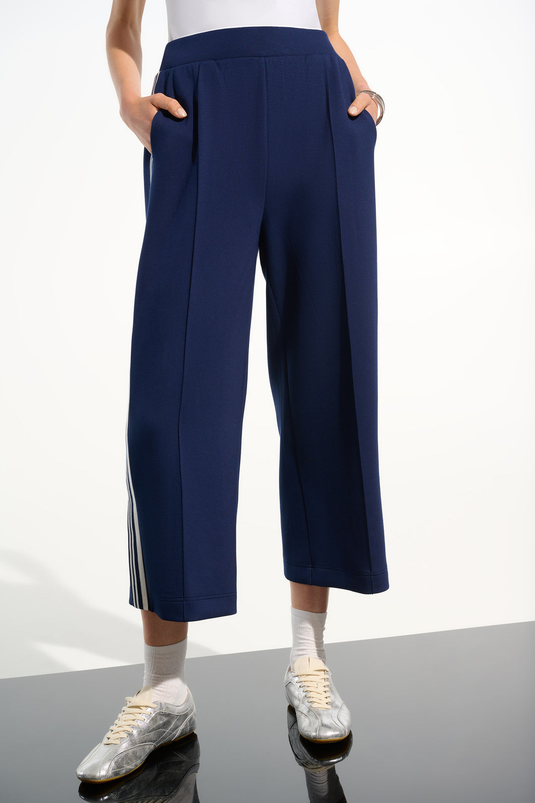 Navy blue wide-leg pants with a white background