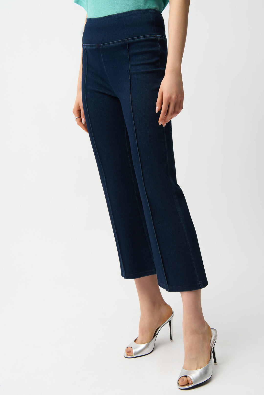 Navy blue capri pants worn by a person on a white background