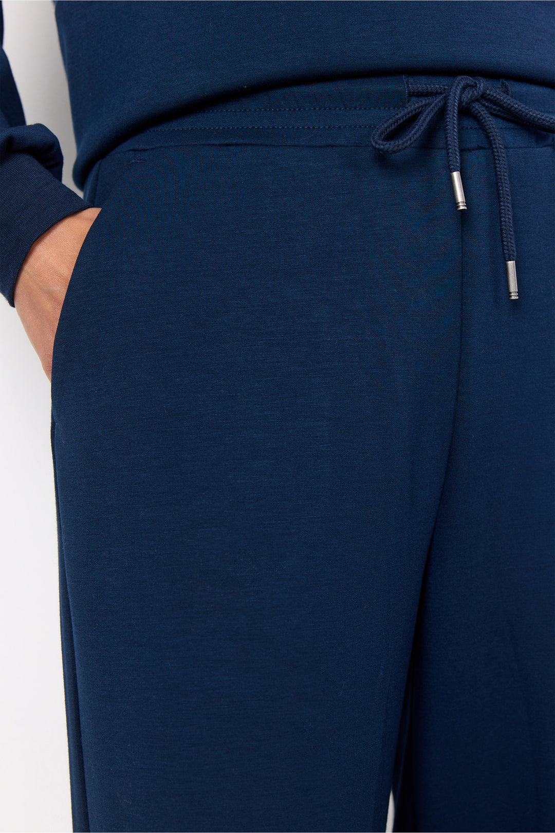 Navy blue jogger pants with a drawstring on a white background