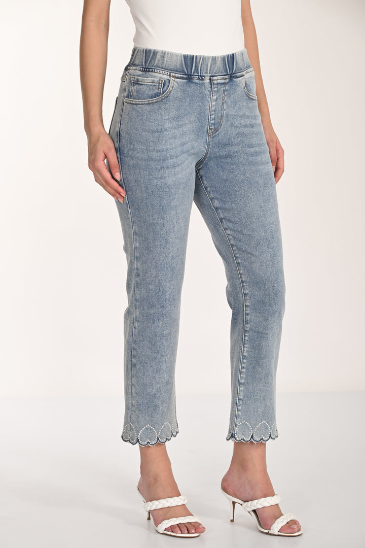 Light blue jeans with scalloped hem hearts worn by a person on a white background