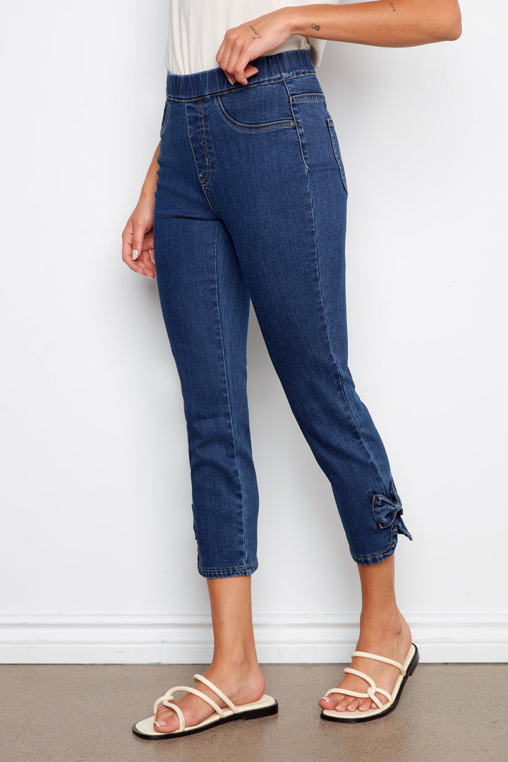 Person wearing blue jeans with a white background