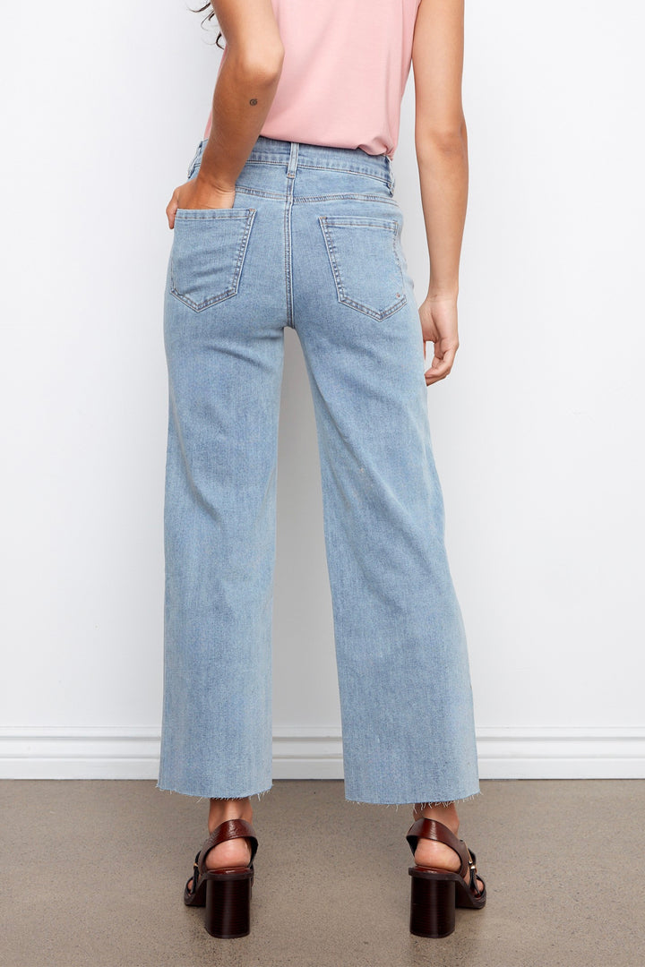 Light blue jeans worn by a person on a plain background