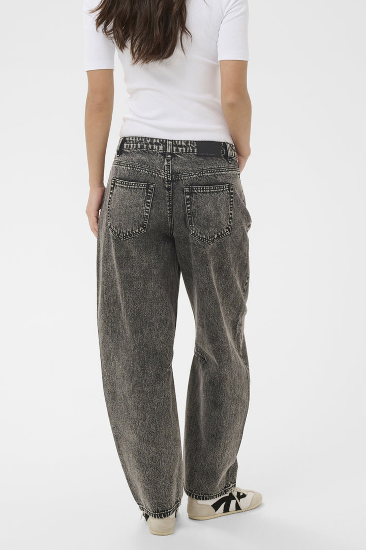 Person wearing gray jeans and a white shirt on a white background