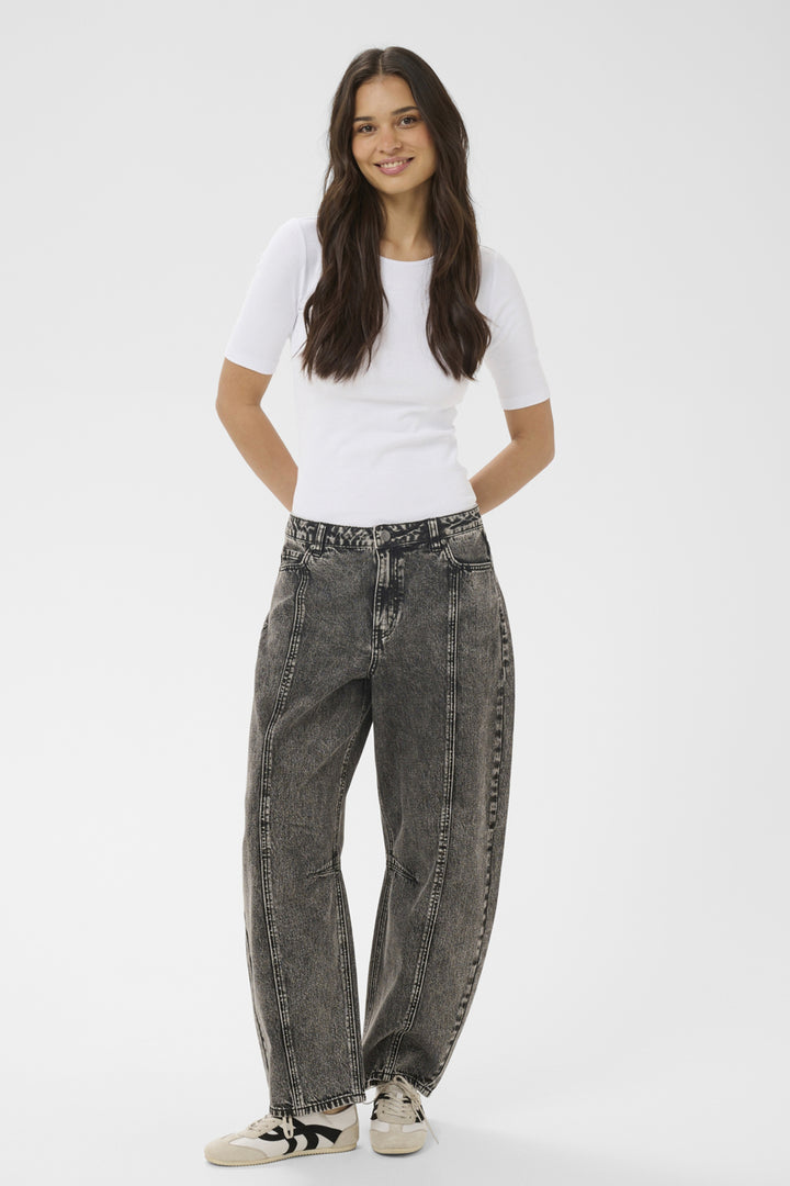 Woman wearing a white t-shirt and gray jeans on a white background