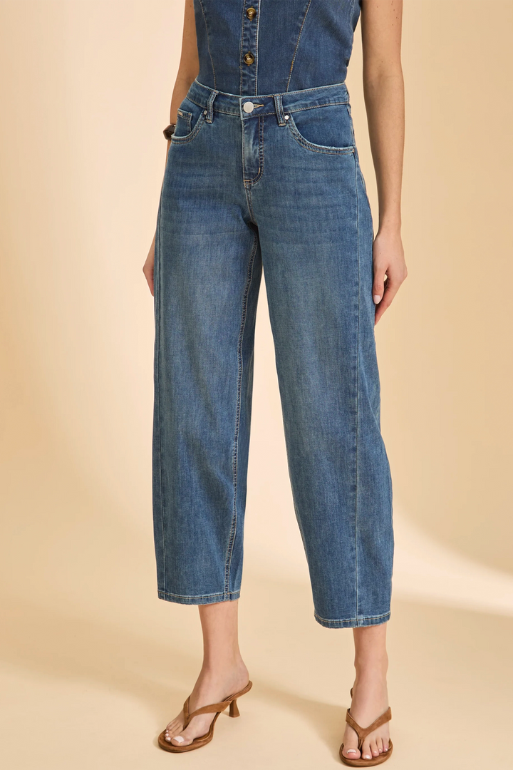 Denim jumpsuit with wide-leg jeans on a beige background