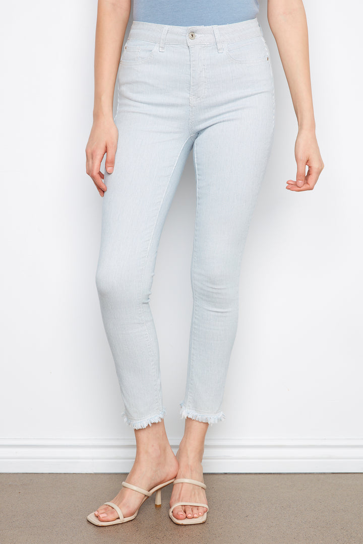 Light blue jeans worn by a person against a white background