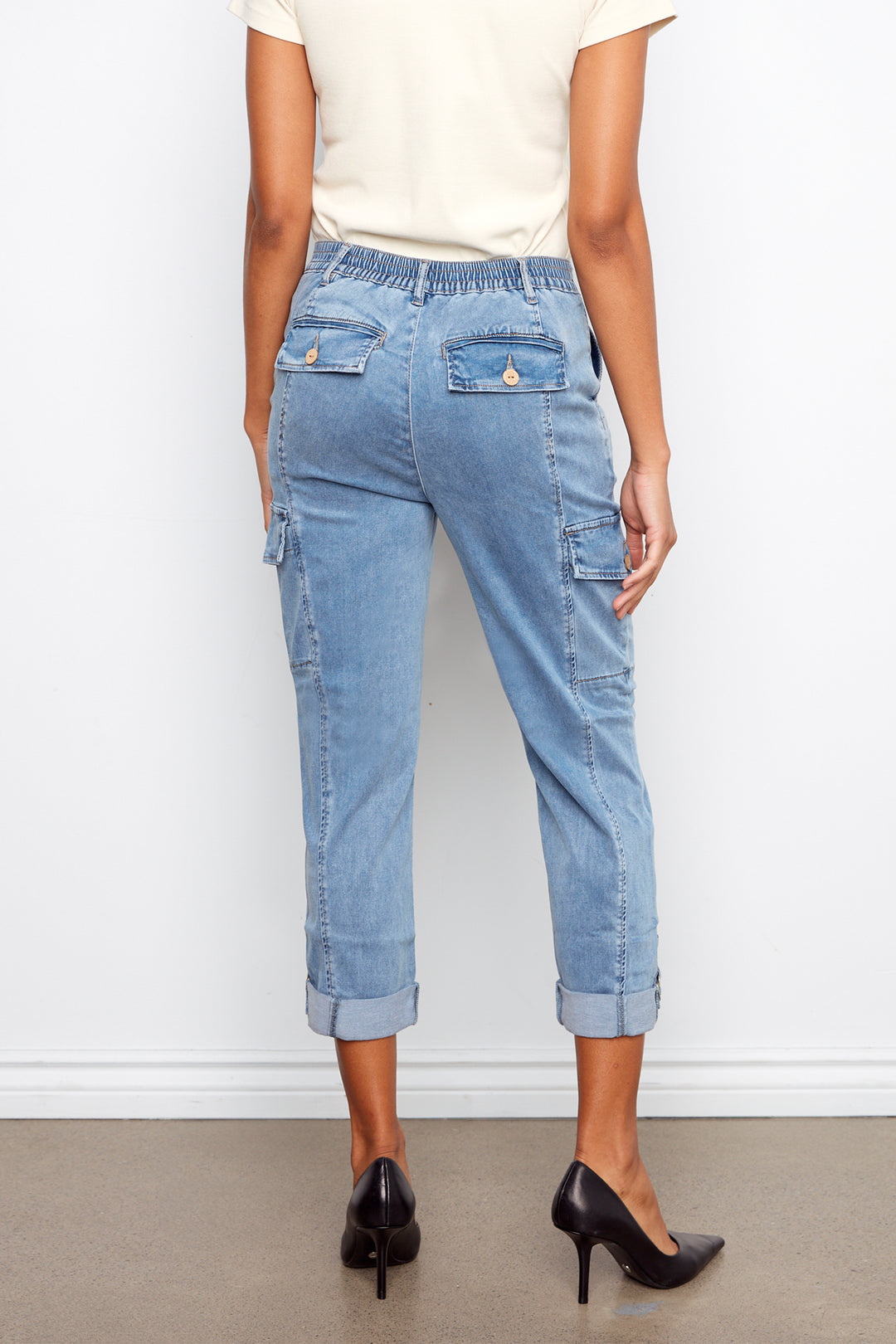 Light blue jeans worn by a person against a white background