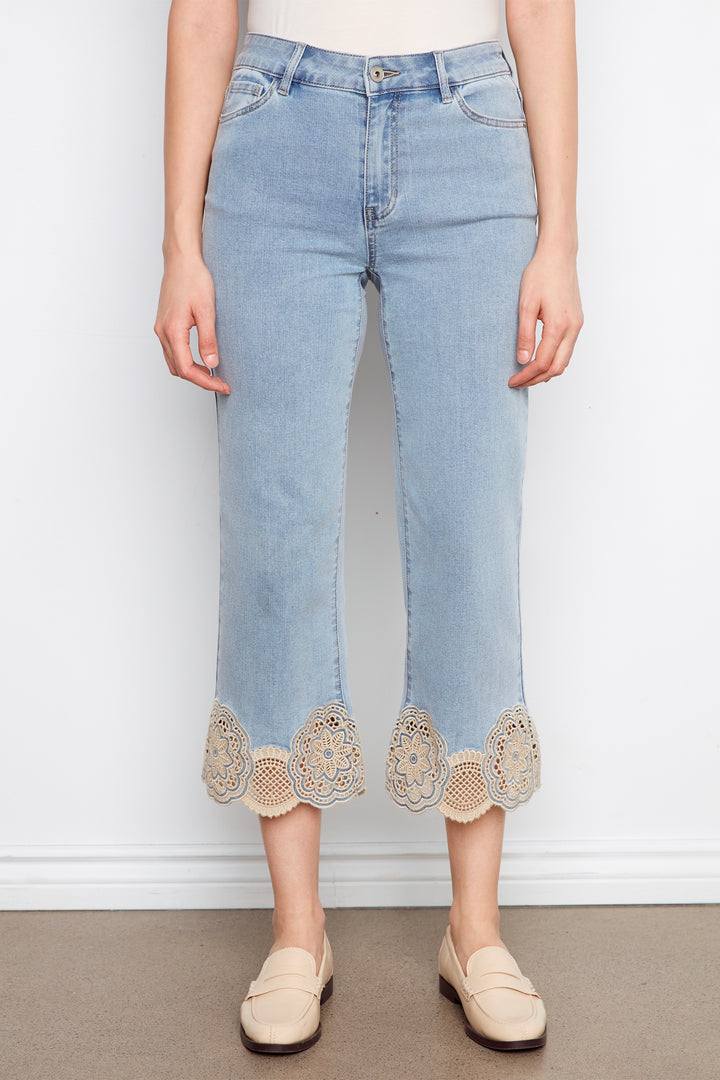 Light blue jeans with lace trim worn by a person on a plain background