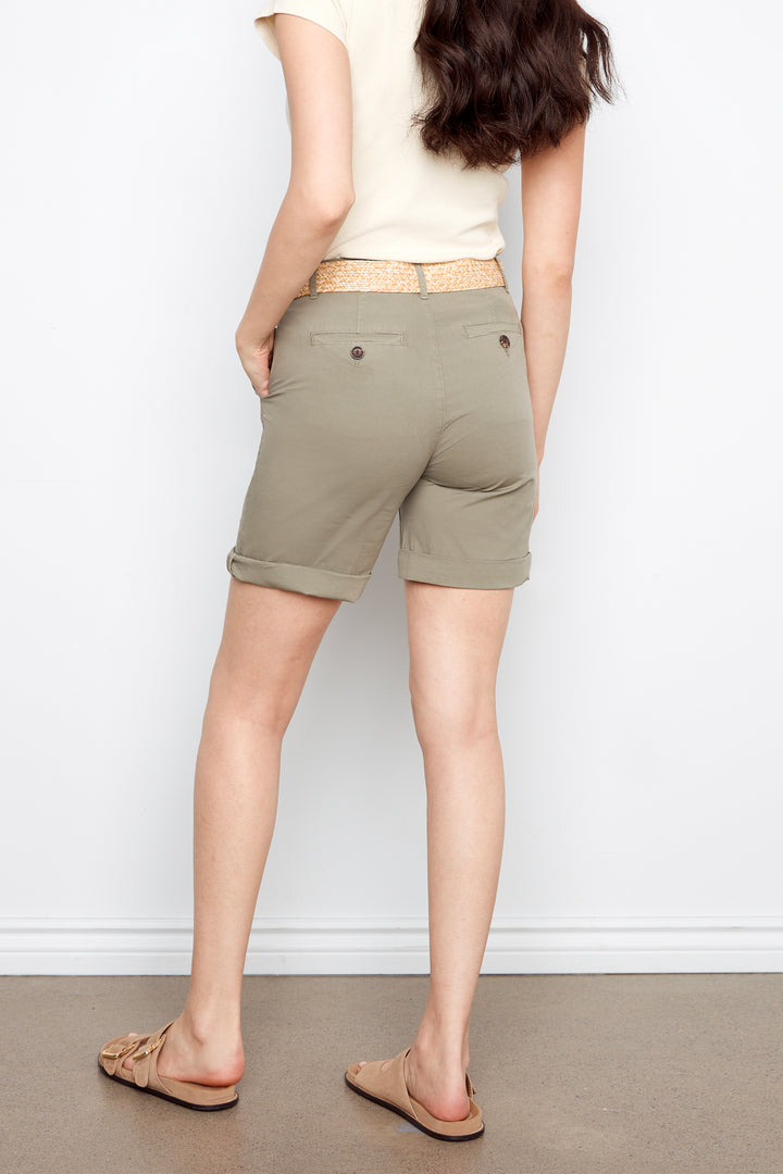Person wearing olive green shorts against a white background