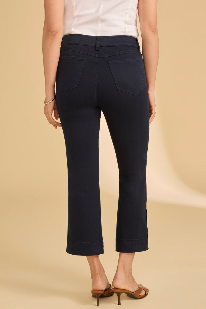 Person wearing navy blue pants on a beige background