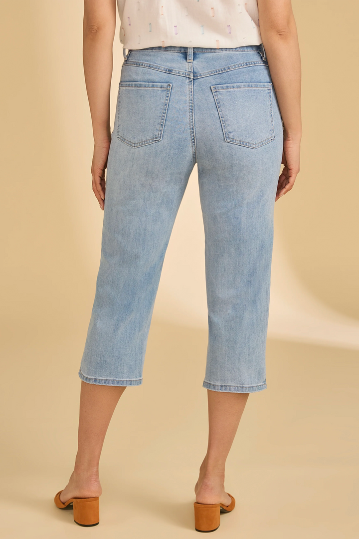 Light blue jeans worn by a person on a beige background