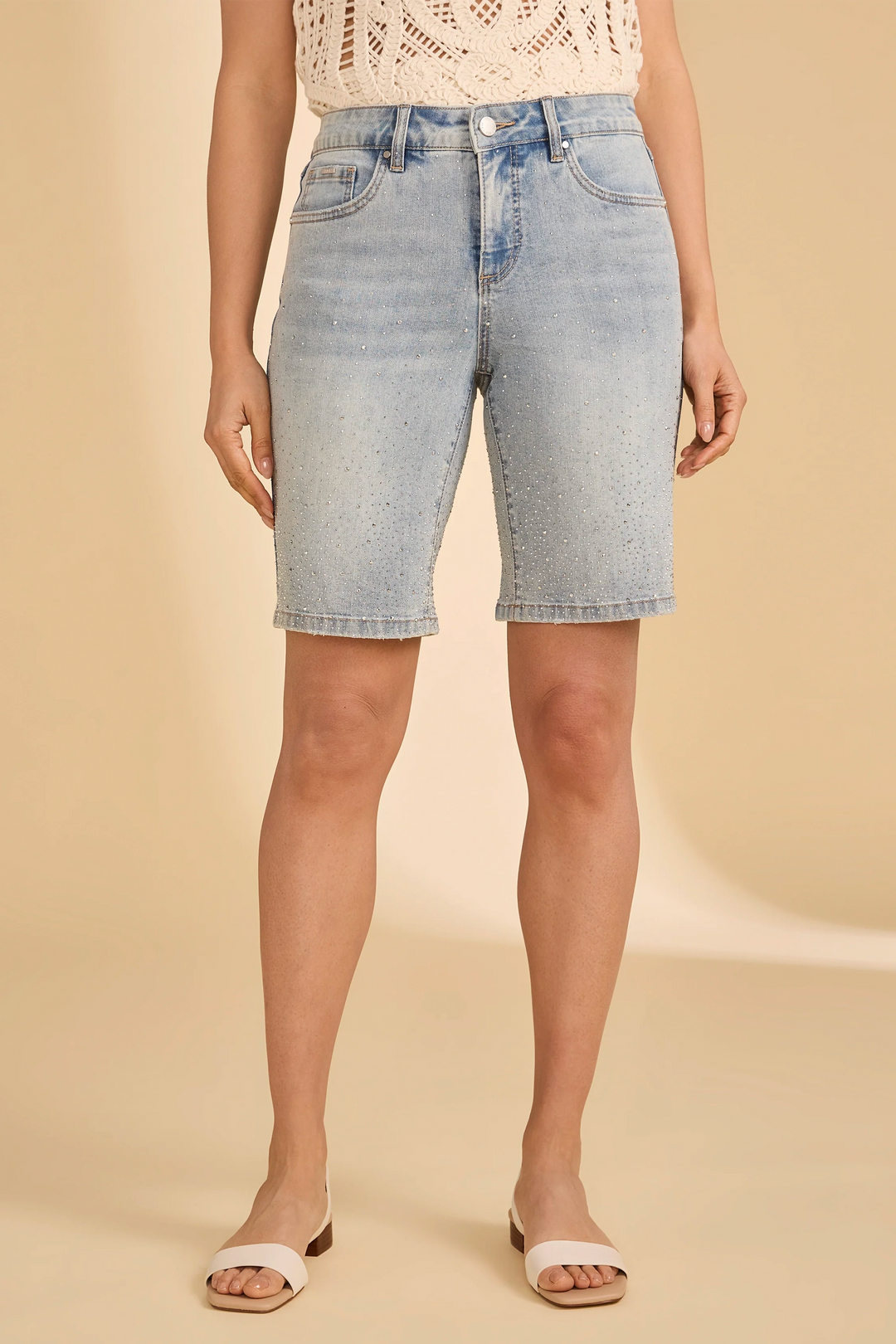 Light blue denim shorts worn by a person on a beige background