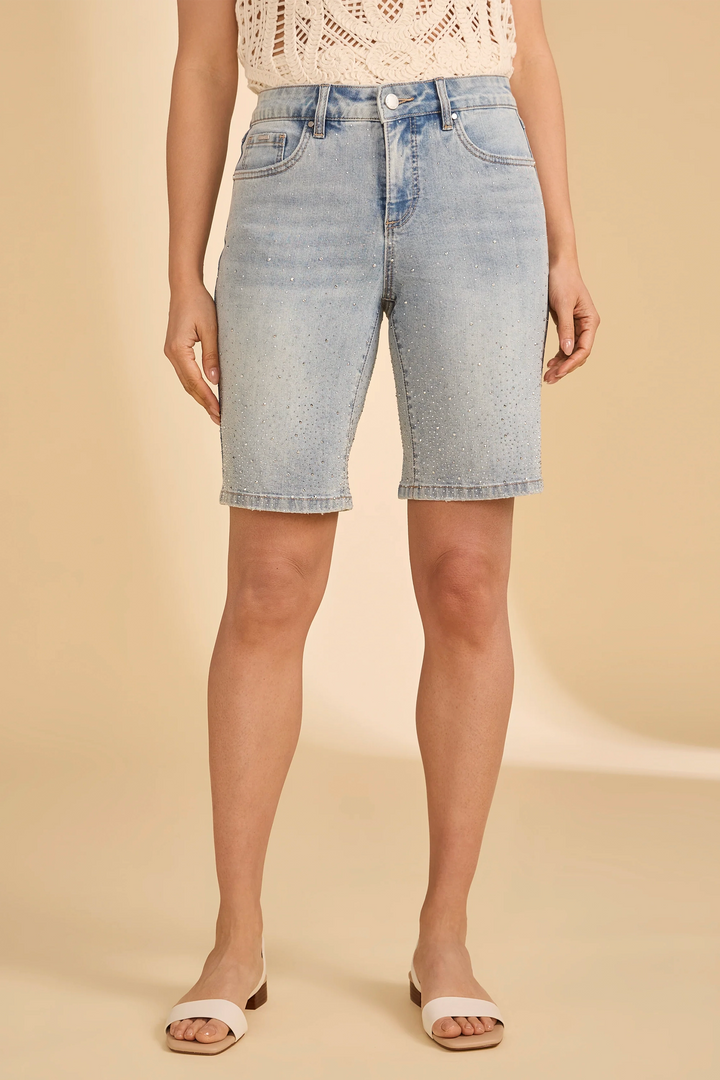 Light blue denim shorts worn by a person on a beige background