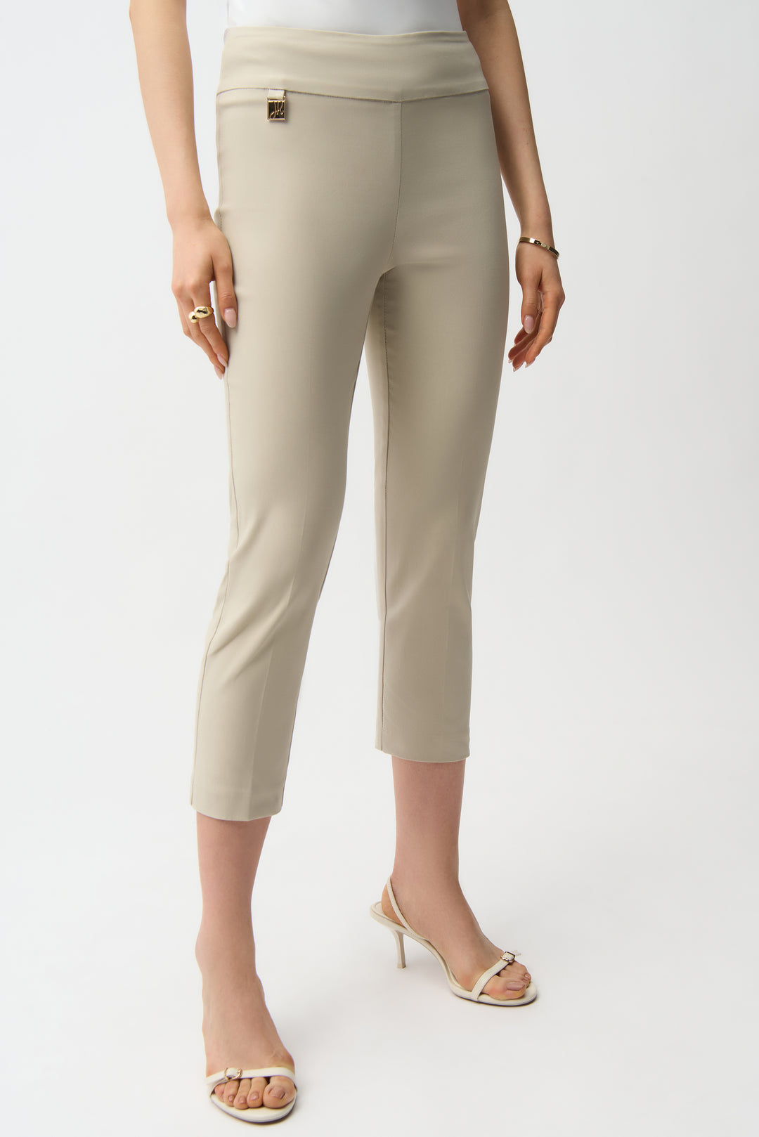 Beige pants worn by a person on a white background