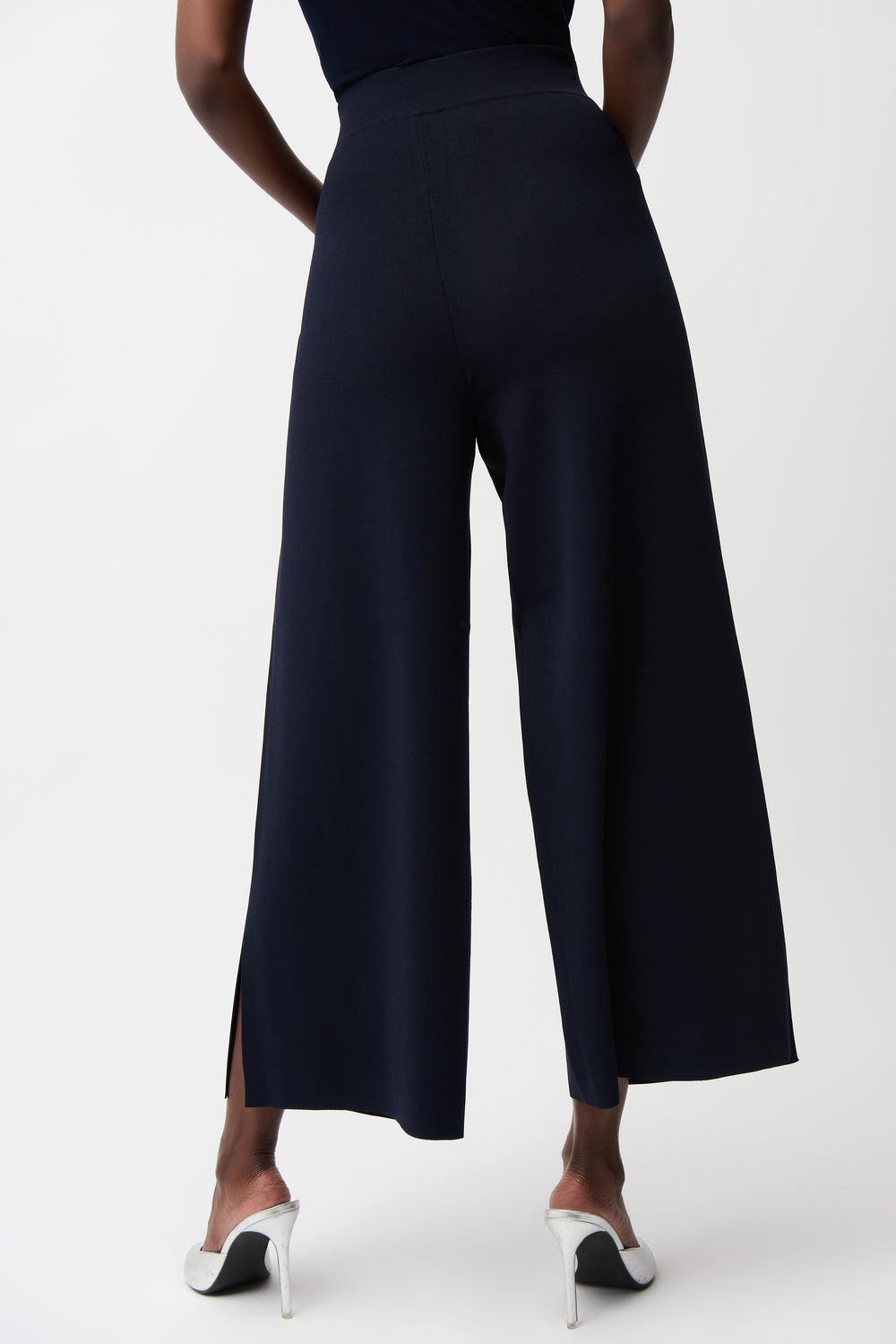 Navy wide-leg pants worn by a person on a white background