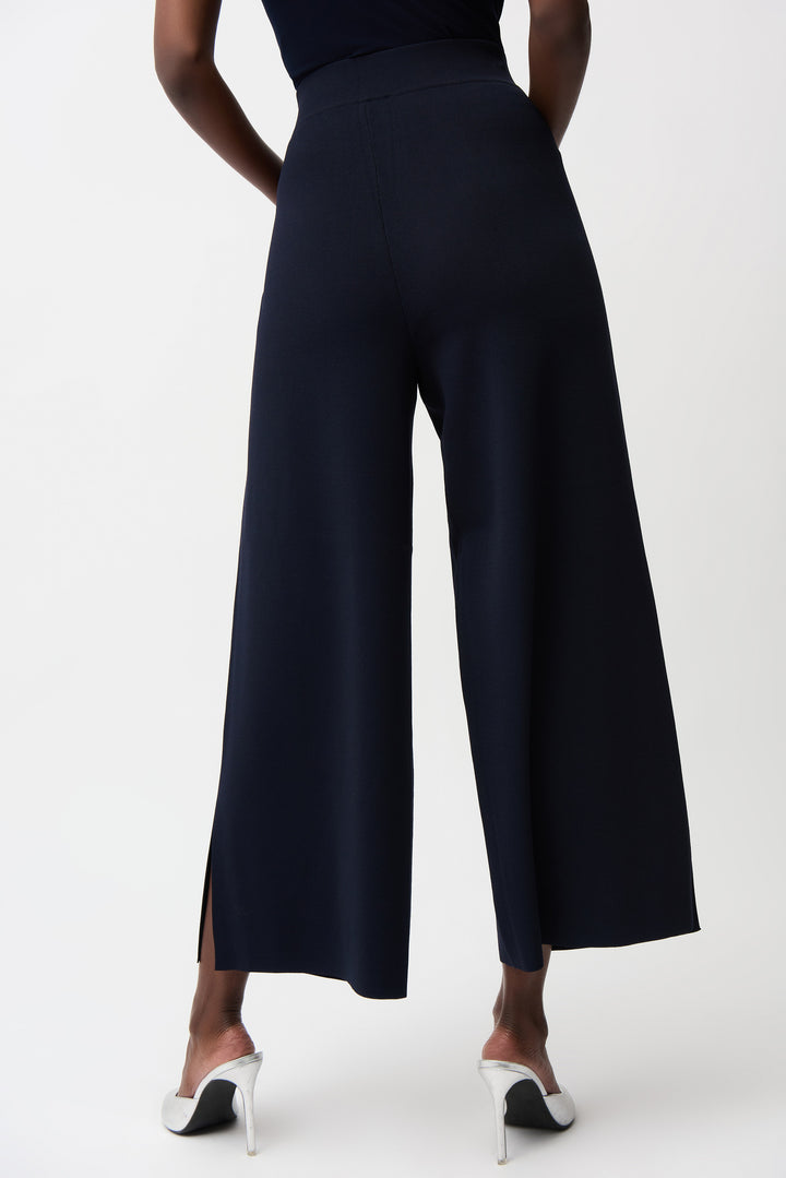 Navy wide-leg pants worn by a person on a white background