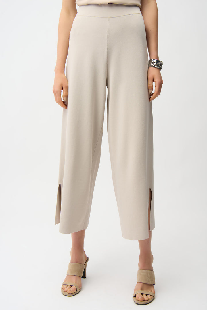 Beige pants worn by a person on a white background