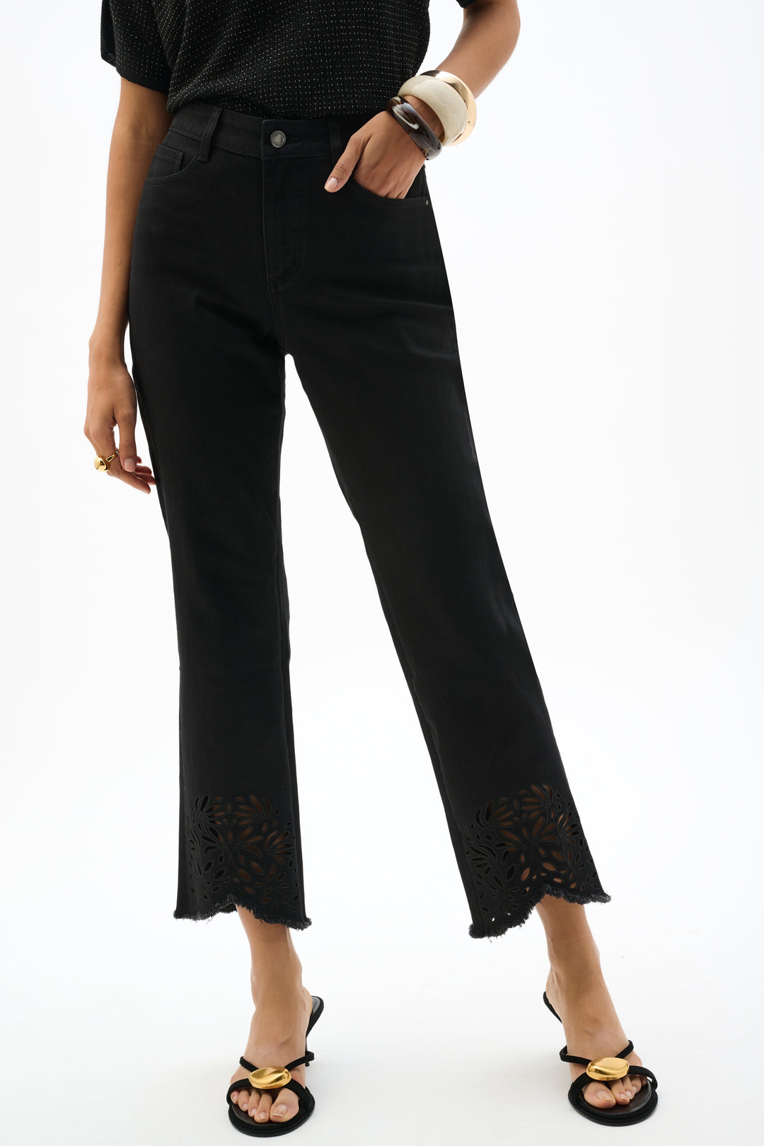 Person wearing black lace-trimmed pants on a white background