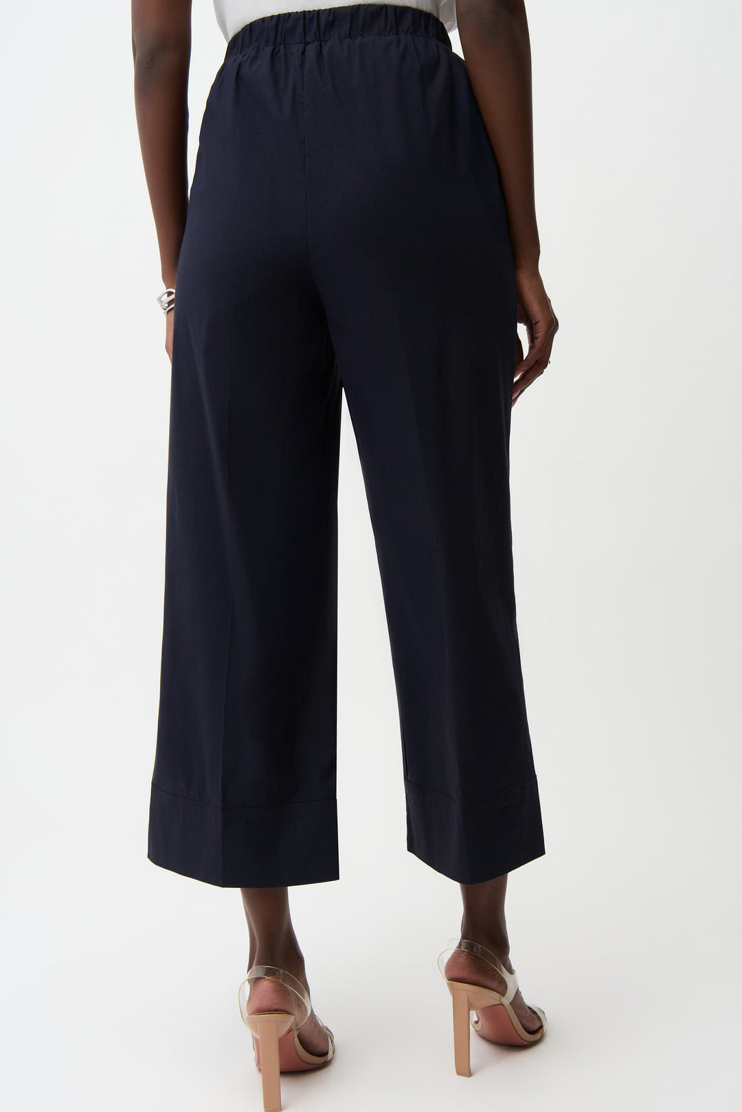Navy blue wide-leg pants worn by a person on a white background