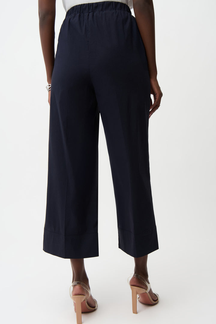 Navy blue wide-leg pants worn by a person on a white background