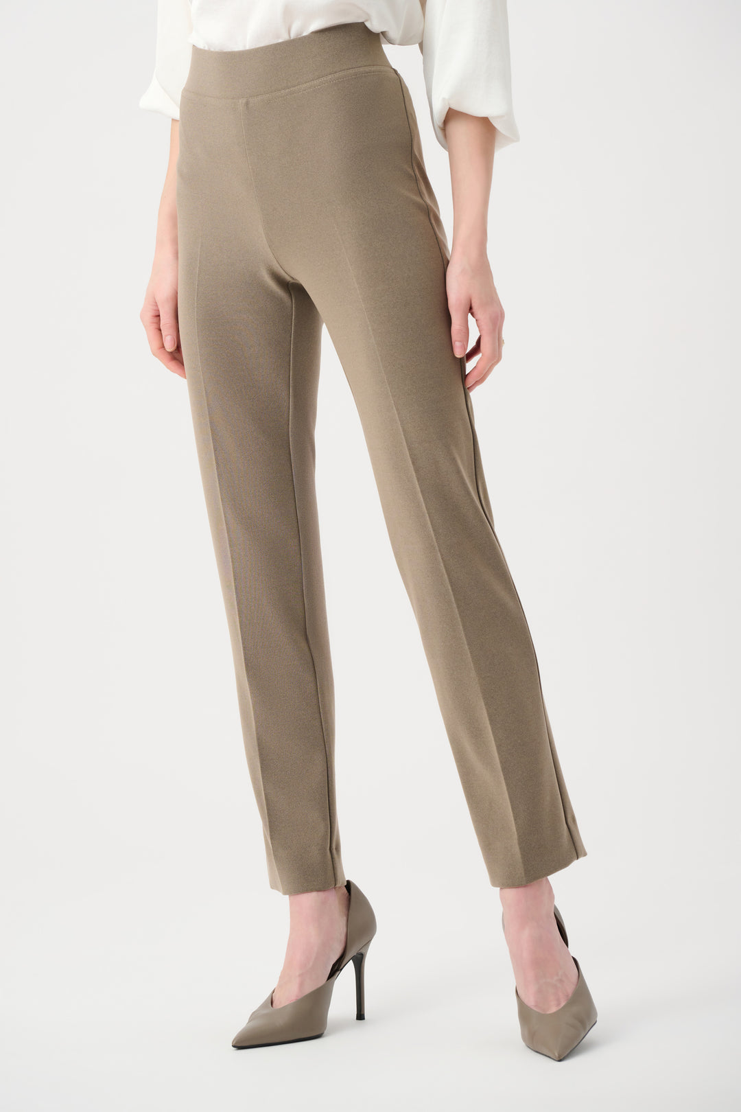 Beige pants worn by a person on a white background