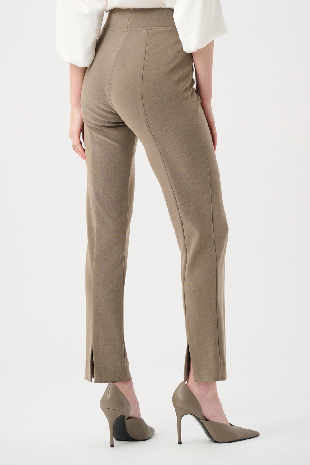 Beige pants worn by a person on a white background