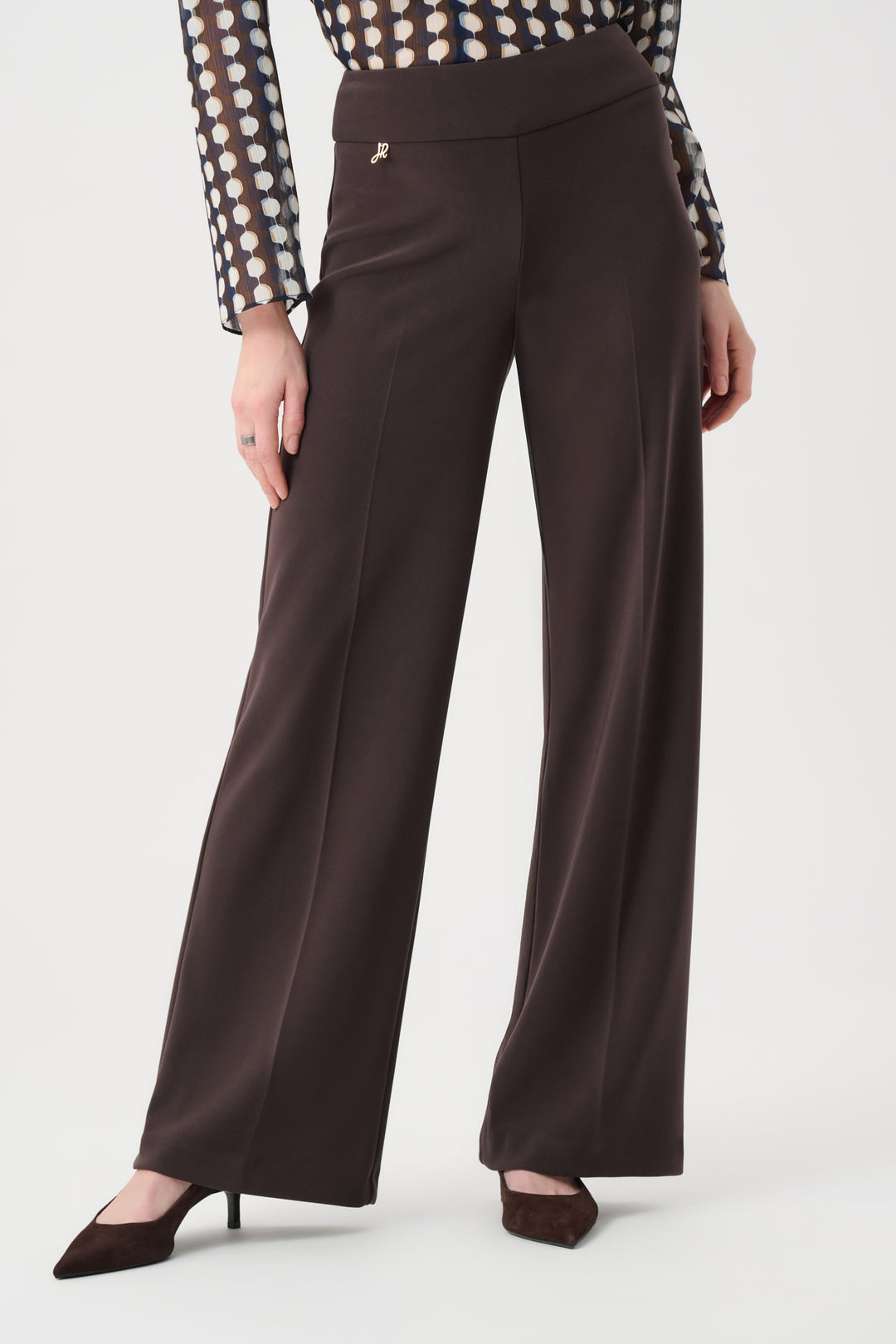 Brown wide-leg pants worn by a person on a white background