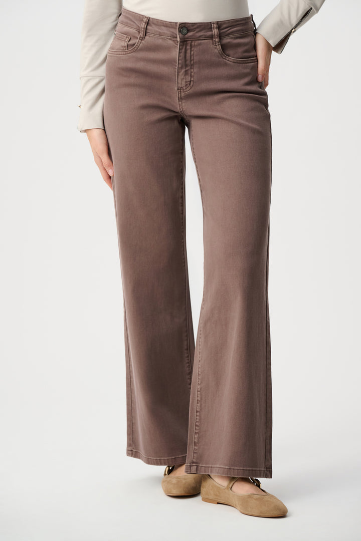 Brown pants worn by a person on a white background
