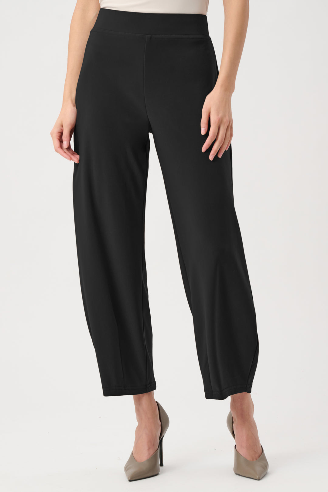 Black pants worn by a person on a white background