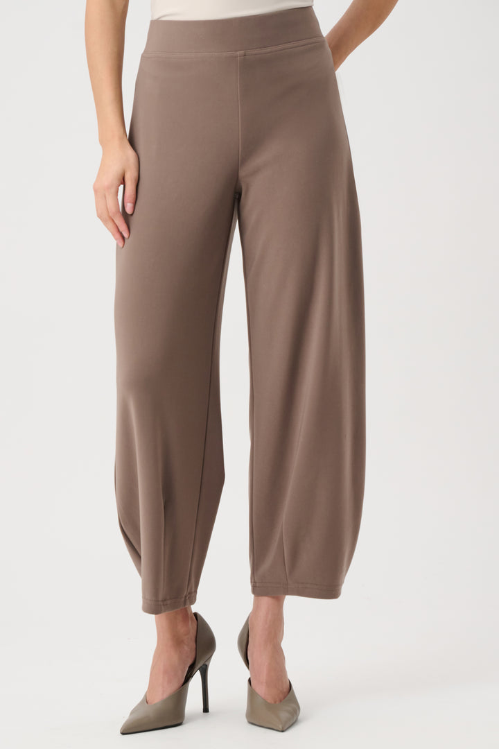 Brown pants worn by a person on a white background