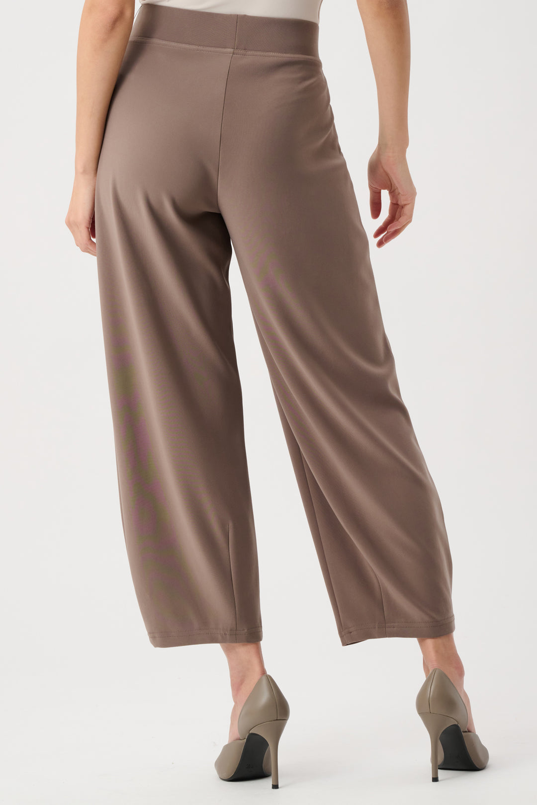 Brown pants worn by a person on a white background