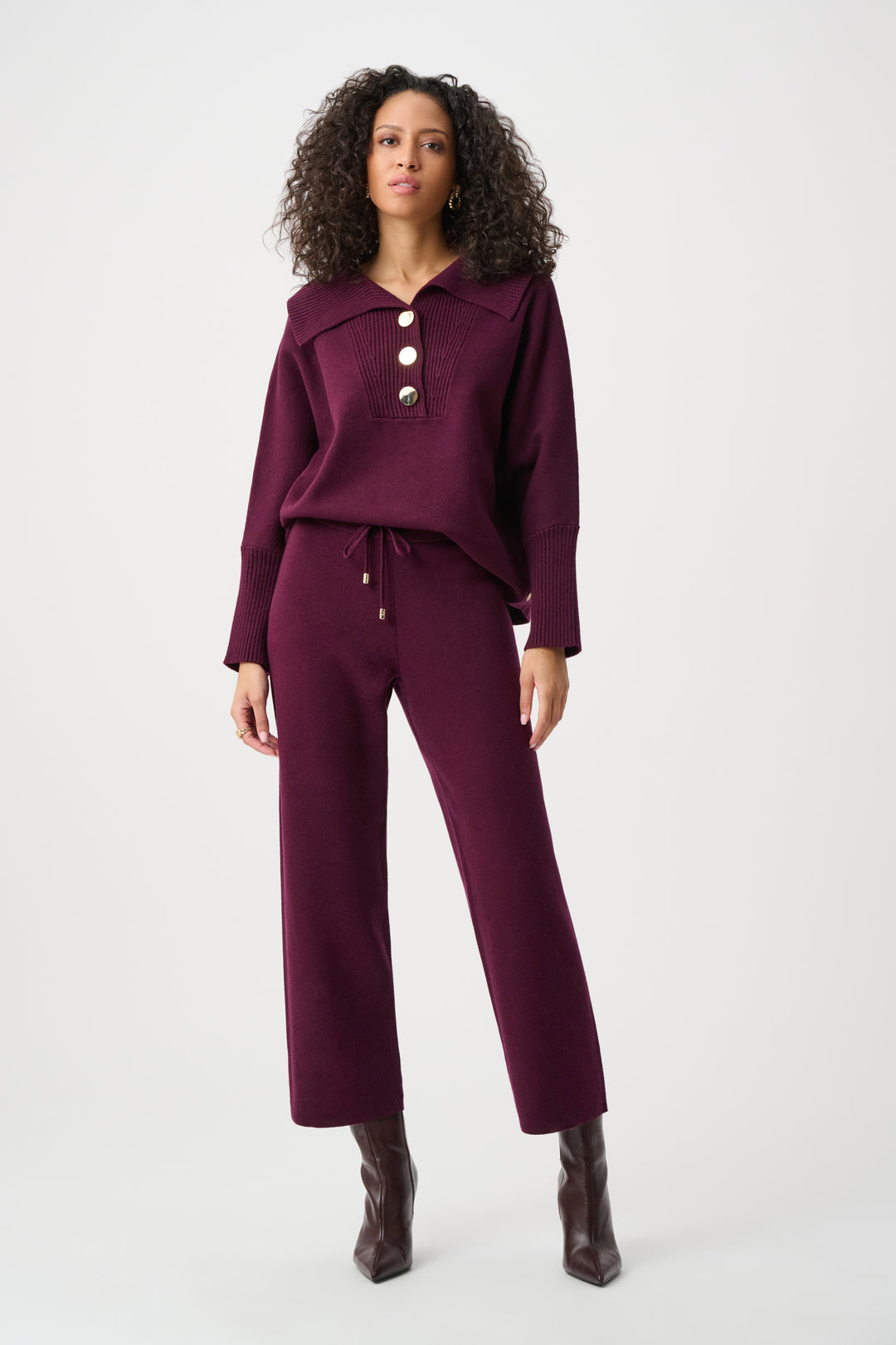 Woman wearing a burgundy outfit with a white background