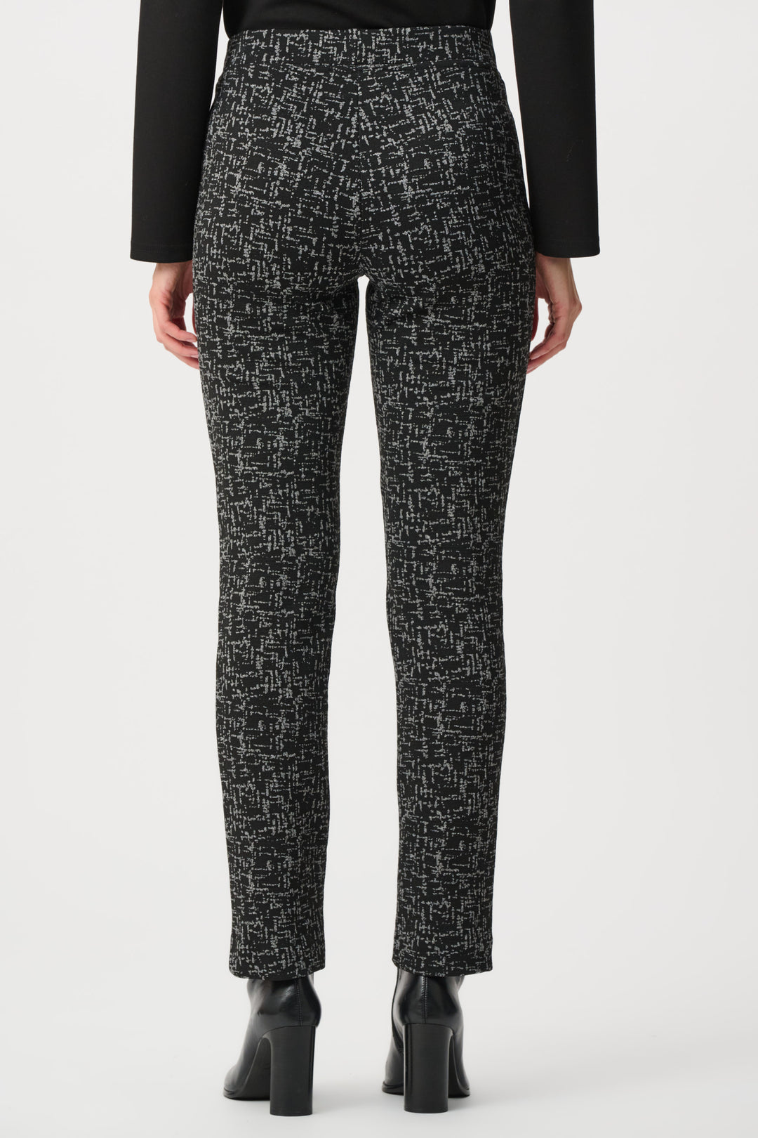 Black and white patterned pants worn by a person on a white background