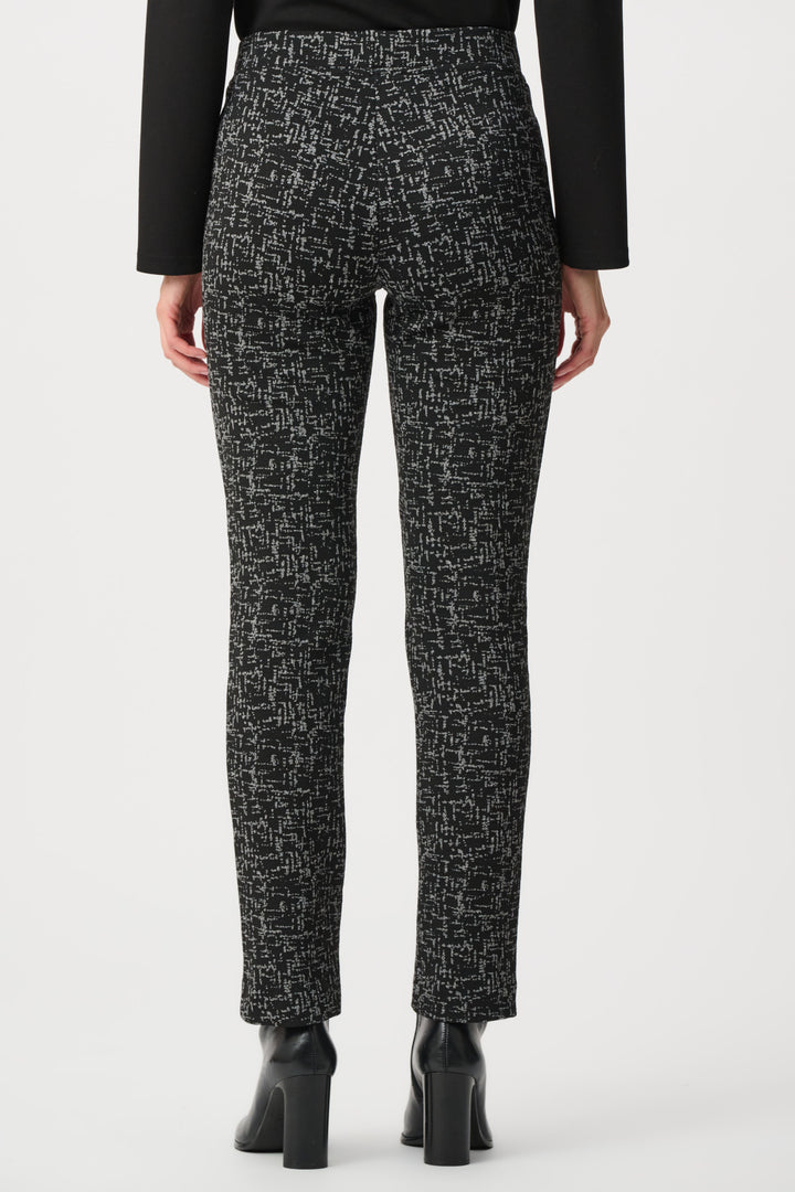 Black and white patterned pants worn by a person on a white background