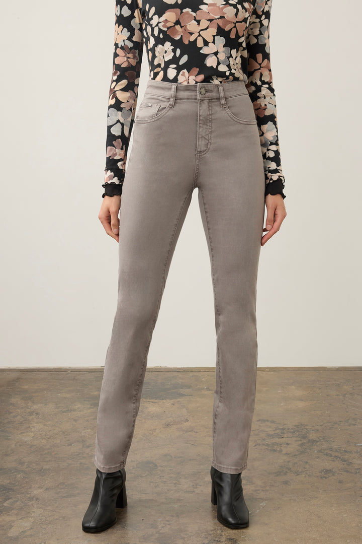 A model wearing high-waisted, straight-leg gray jeans, paired with a black floral long-sleeve top and black ankle boots, standing against a neutral studio background.