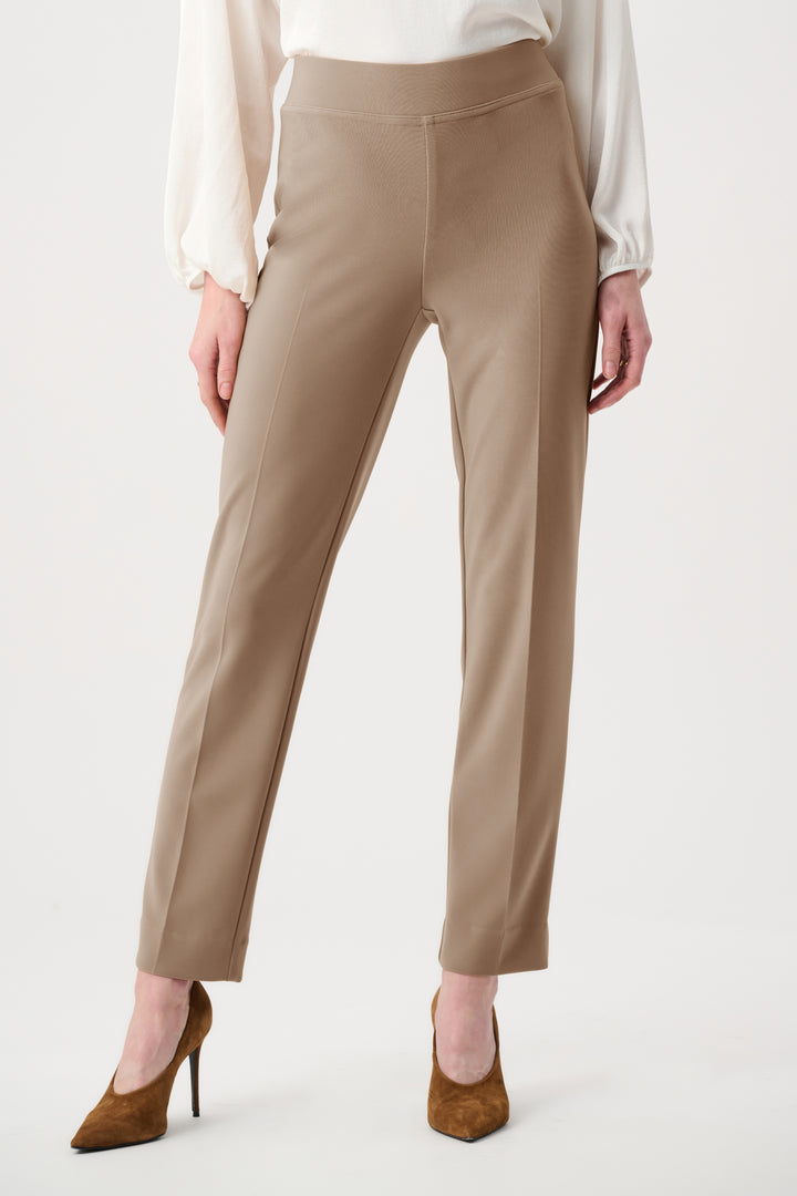 Beige pants worn by a person on a white background