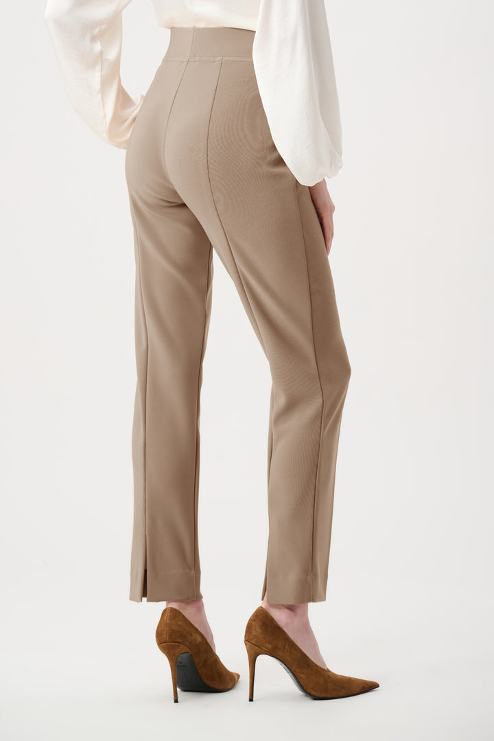 Beige pants worn by a person on a white background