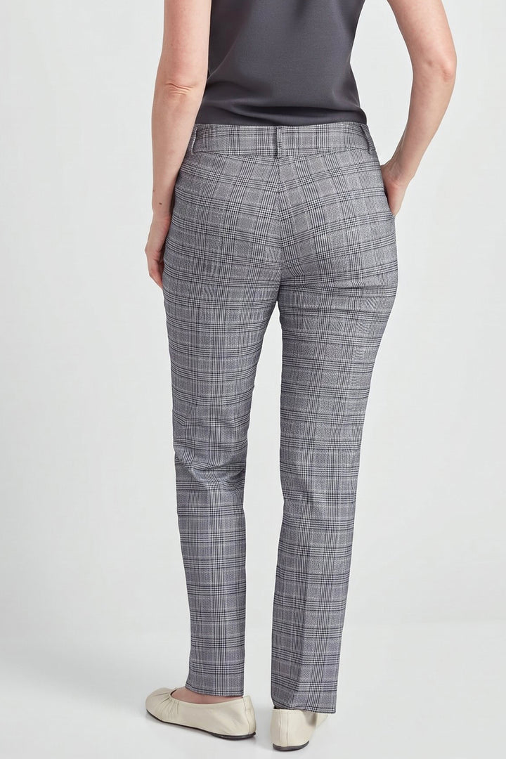 A person shown from the back wearing gray plaid trousers, a dark gray sleeveless top, and light beige flats against a light gray studio background.
