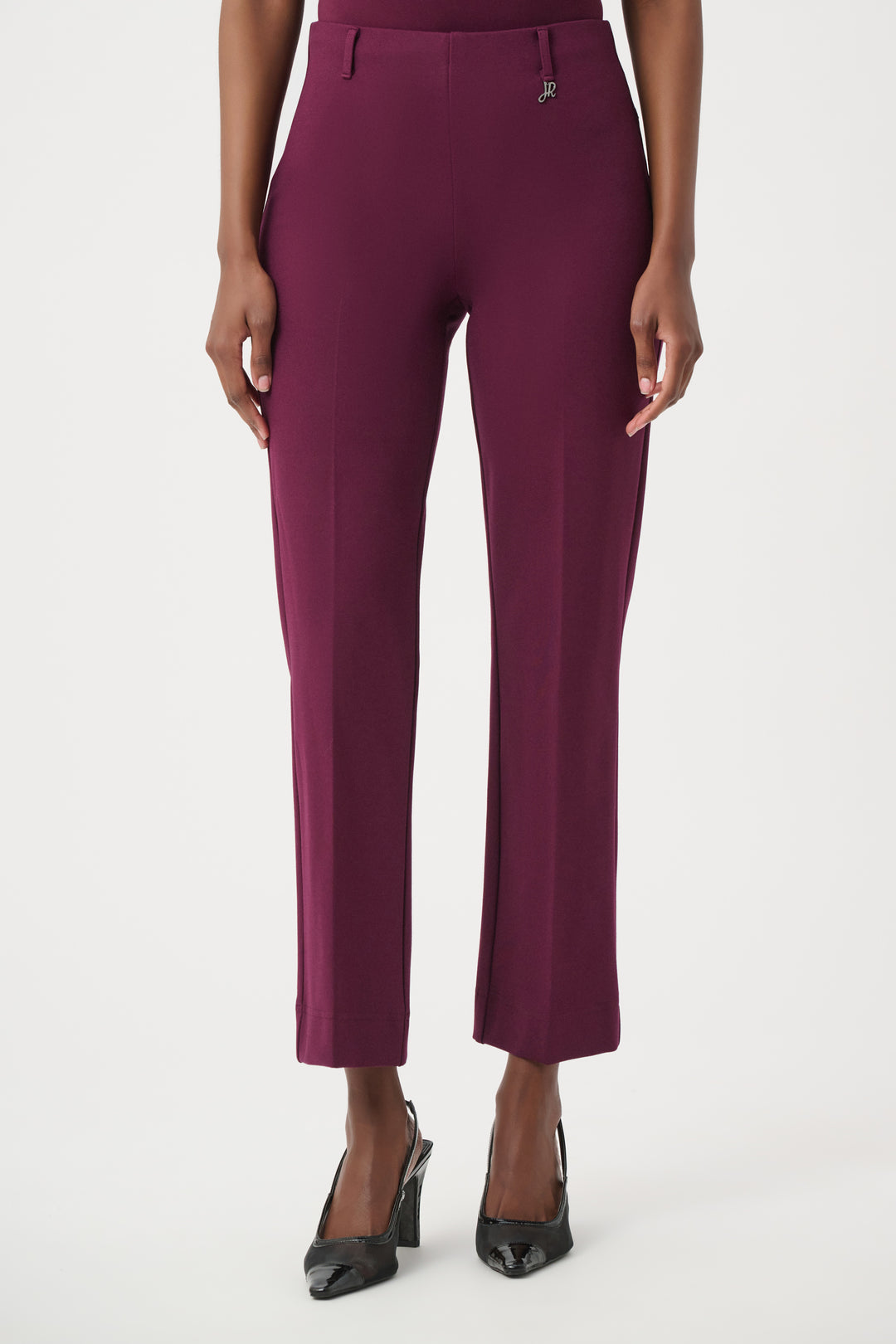 Purple pants worn by a person on a white background