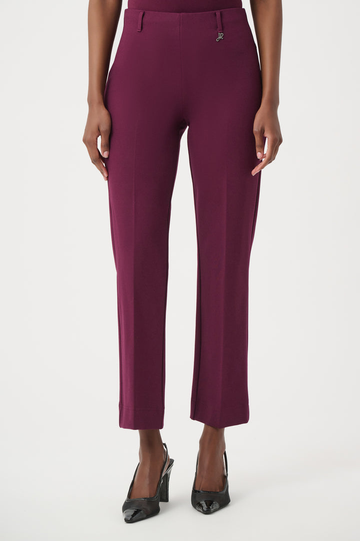 Purple pants worn by a person on a white background