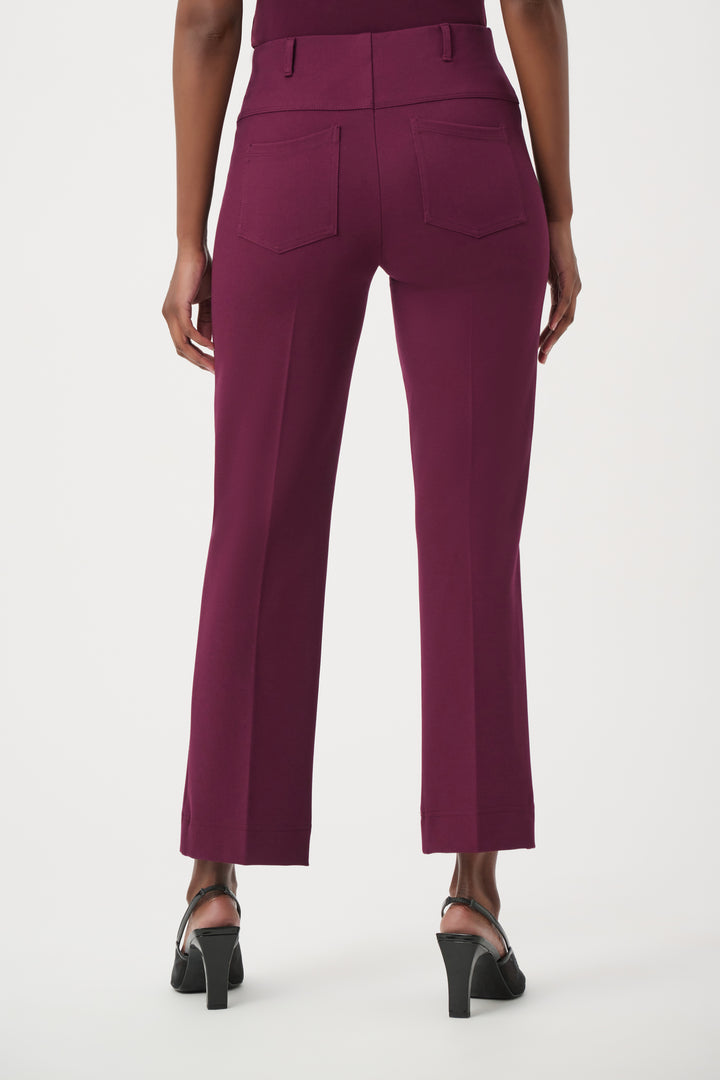 Purple pants worn by a person on a white background