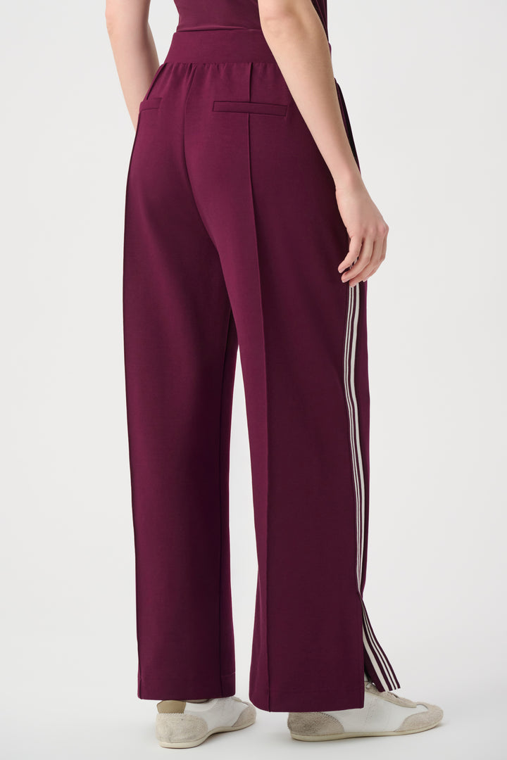 Maroon pants with white stripes on a white background