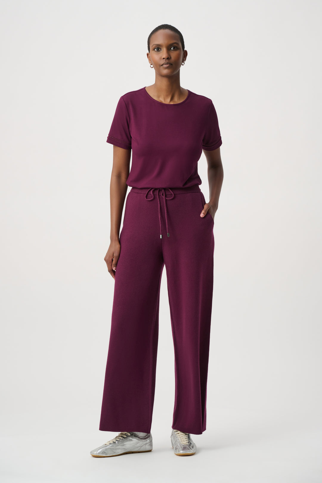 Woman wearing a purple outfit on a white background