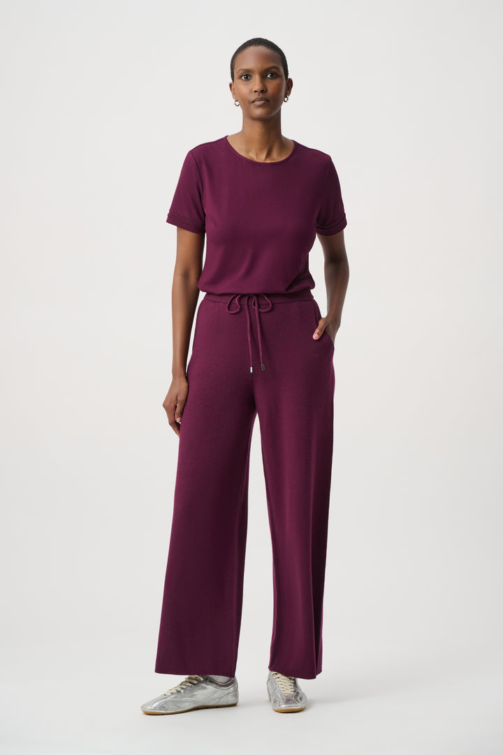 Woman wearing a purple outfit on a white background