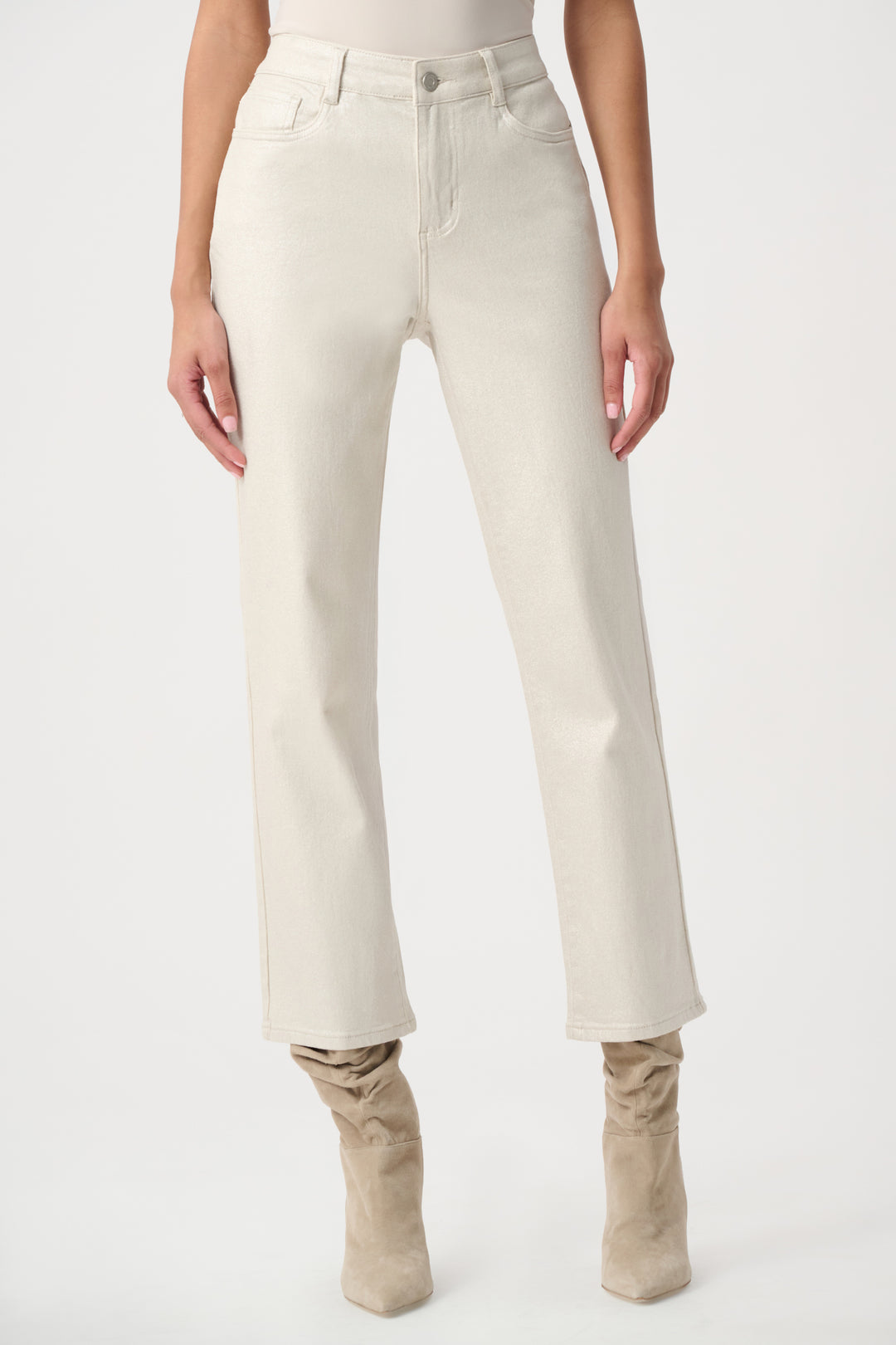 A woman modelling a white pair of metallic jeans with a pink sweater. 
