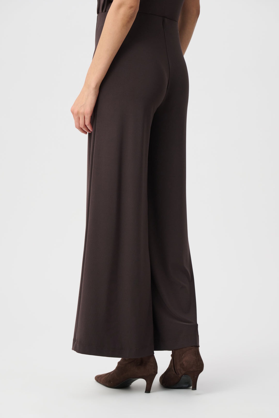 Brown jumpsuit worn by a person on a white background