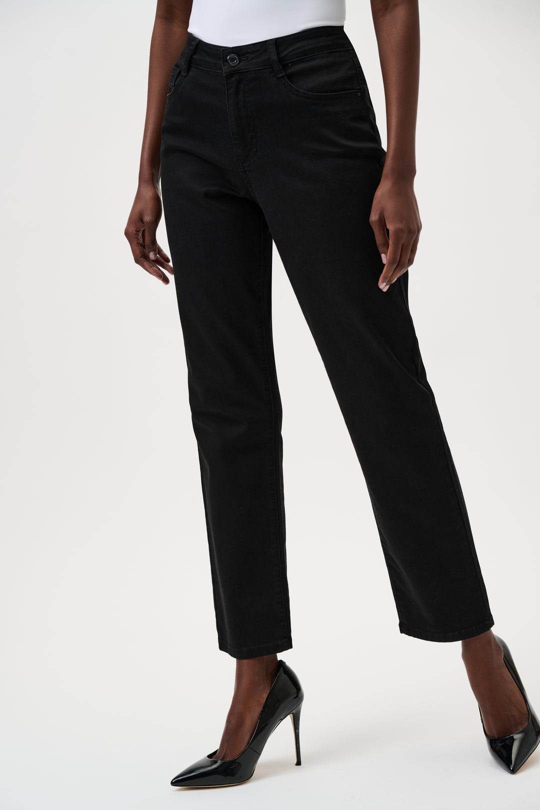 Person wearing black jeans on a white background