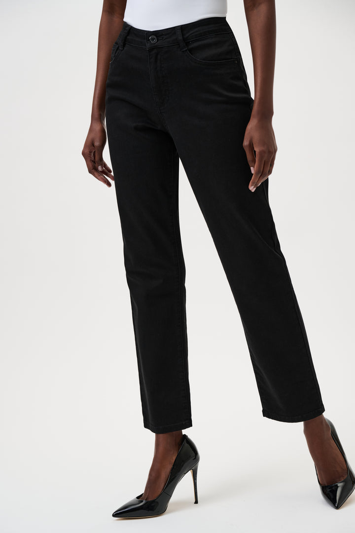 Person wearing black jeans on a white background
