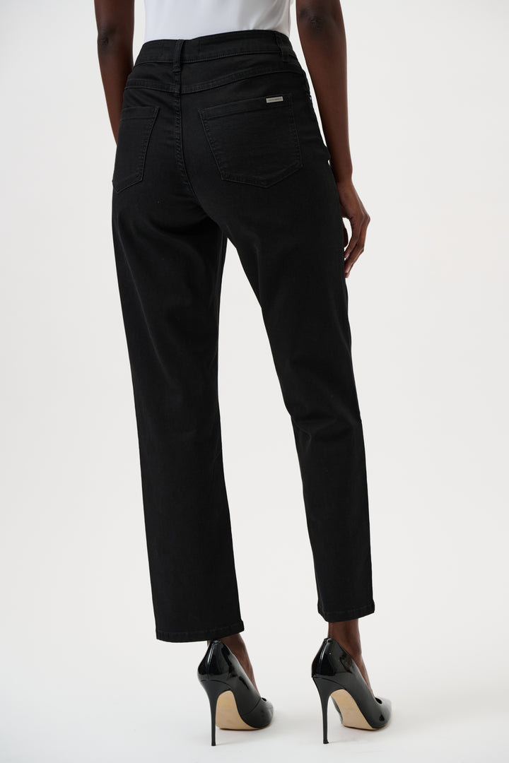 Black jeans worn by a person on a white background